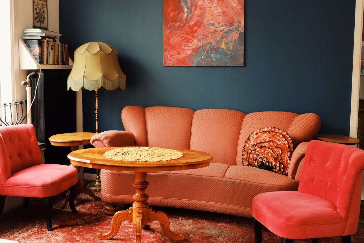 A warm, vintage-style living room in Jönköping, featuring pink velvet seating.